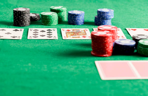 Top view of poker chips and cards on the green table. Poker game concept.